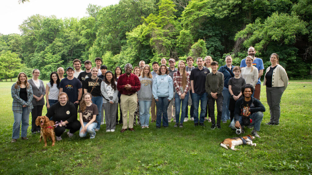 Purdue veterinary summer research scholars and their faculty mentors, along with a couple of canine companions, gathered for a group photo at the site of their welcome picnic in West Lafayette’s Happy Hollow Park May 29.