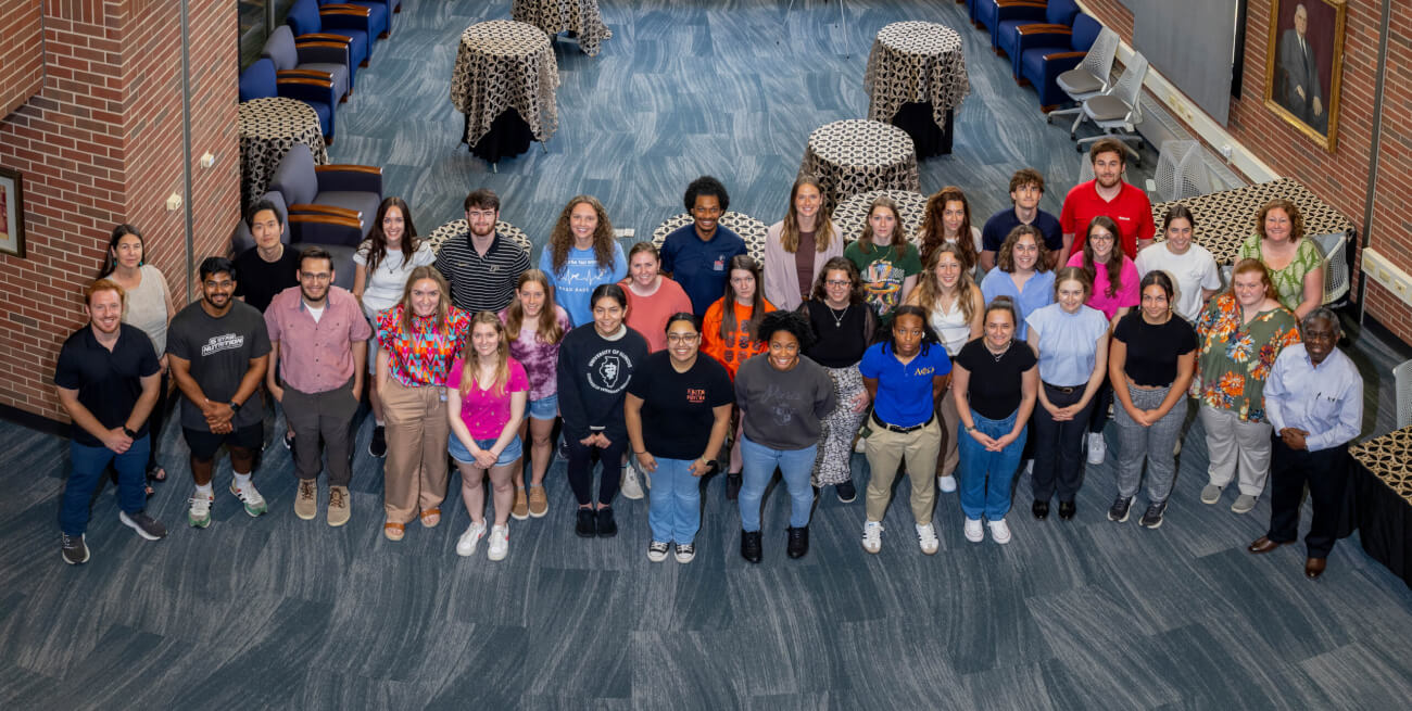 Participants in the 13th Annual Joint Symposium of Purdue University and University of Illinois Veterinary Scholars gathered for a group photo in the Veterinary Medical Library during the one day event June 25.