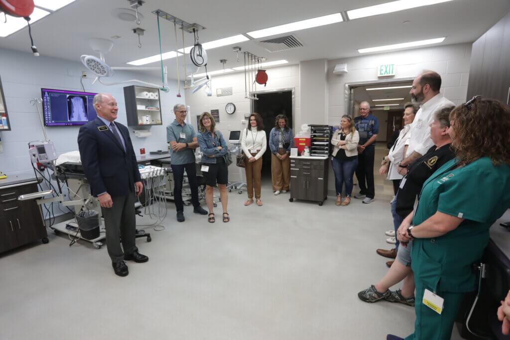Purdue Veterinary Medicine Dean Bret Marsh (left) welcomed conference attendees to the new Dr. Janet Houghton Dental Suite during a reception that honored Dr. Houghton (fourth from left) and gave visitors a chance to see the new educational and clinical resource. 
