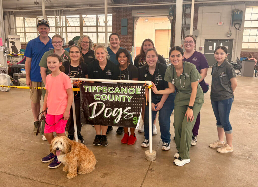 Indiana State Fair 4H Dog Show participant Katie Raines of the Hamilton County 4H Club, and her dog Sandy, with Purdue Veterinary Medicine team members who performed pre-show dog examinations.