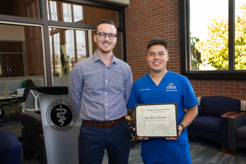 Third-year veterinary student Jose Meza Sanchez displays his Global Veterinary Medicine certificate in a photo op with Addison Sheldon.