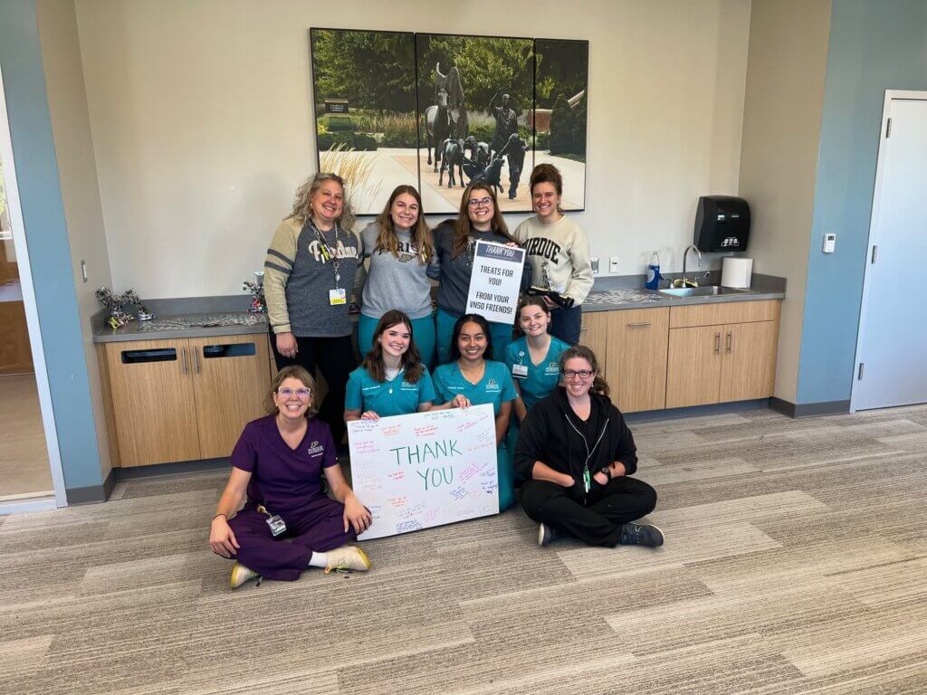 Veterinary Nursing Student Organization (VNSO) members with Veterinary Technology Program staff at the VNSO Vet Tech Week event where they displayed a Thank You poster signed by students for the vet techs in the Purdue University Veterinary Hospital.