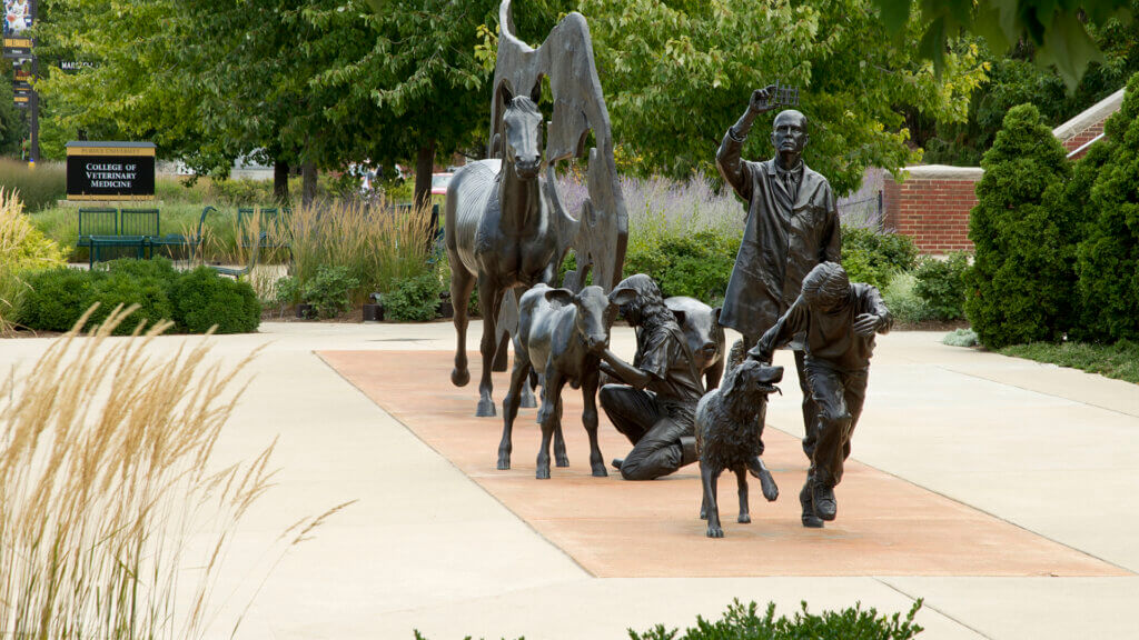 an outdoor sculpture featuring humans and animals