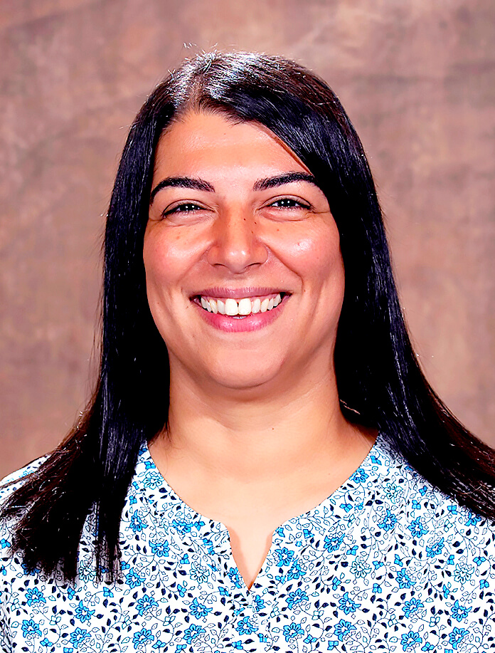 portrait of a woman smiling and wearing a blue shirt