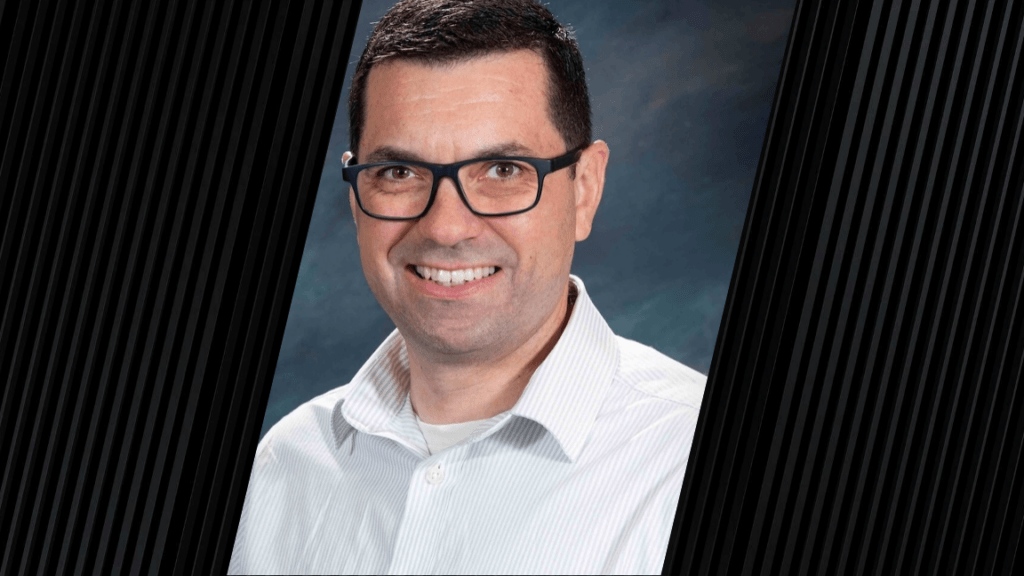 man wearing glasses and a white button-up shirt