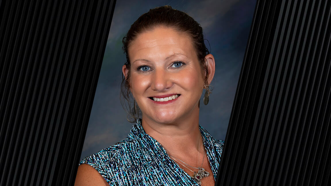 woman wearing a blue sleeveless shirt and necklace