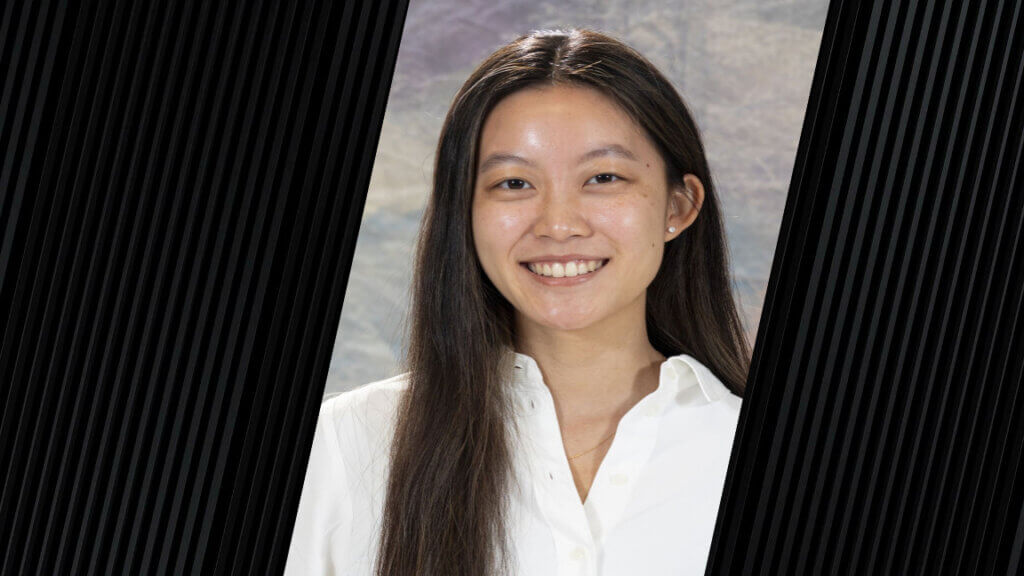 portrait of a woman who is wearing a white button-up shirt and who has long, dark hair