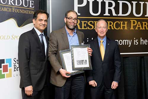 PVM Associate Professor of Microbiology Mohamed Seleem, who was honored for receiving two issued patents, is joined by Purdue Executive Vice President for Research and Partnerships Suresh Garimella (left) and President Mitch Daniels at the 12th Annual Inventors Recognition Reception February 8. (Purdue University photo/John Underwood)
