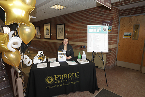 Marisol Uribe, administrative assistant for the Office for Diversity and Inclusion, hosts a welcome table on the ground floor east entrance to Lynn Hall.