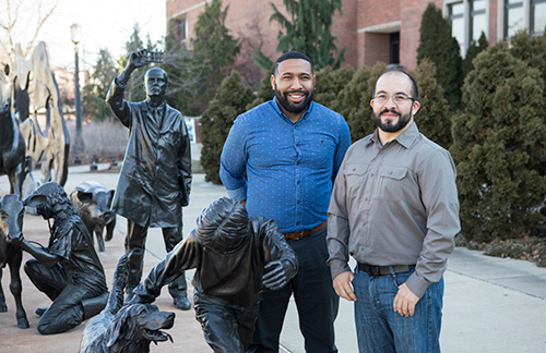 Veterinarian Alejandro Morales (right), assistant director of ARCAS in Peten, Guatemala, braves the Indiana winter for an outdoor photo-op by the Continuum sculpture with Will Smith, II, PVM director of international programs.