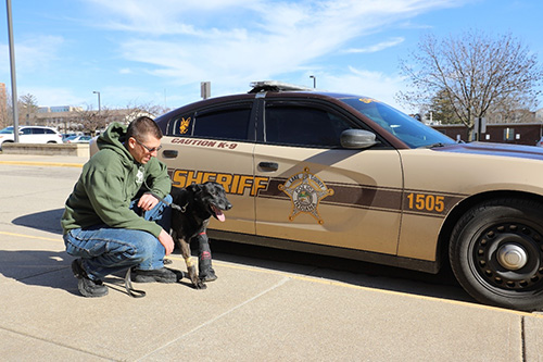 Deputy Doug Parker of the Lake County Indiana Sherriff's Department with Rocky, a six-year veteran K9 officer that was injured in an interstate car chase in Northwest Indiana. Rocky was brought by helicopter to Purdue University, where he received emergency treatment at the VTH for a broken bone in his left paw.