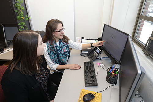 Dr. Maggie O'Haire reviews research information with study co-author Kerri Rodriguez, who is part of the Organization for Human-Animal Interaction Research and Education (OHAIRE) research group at Purdue University.