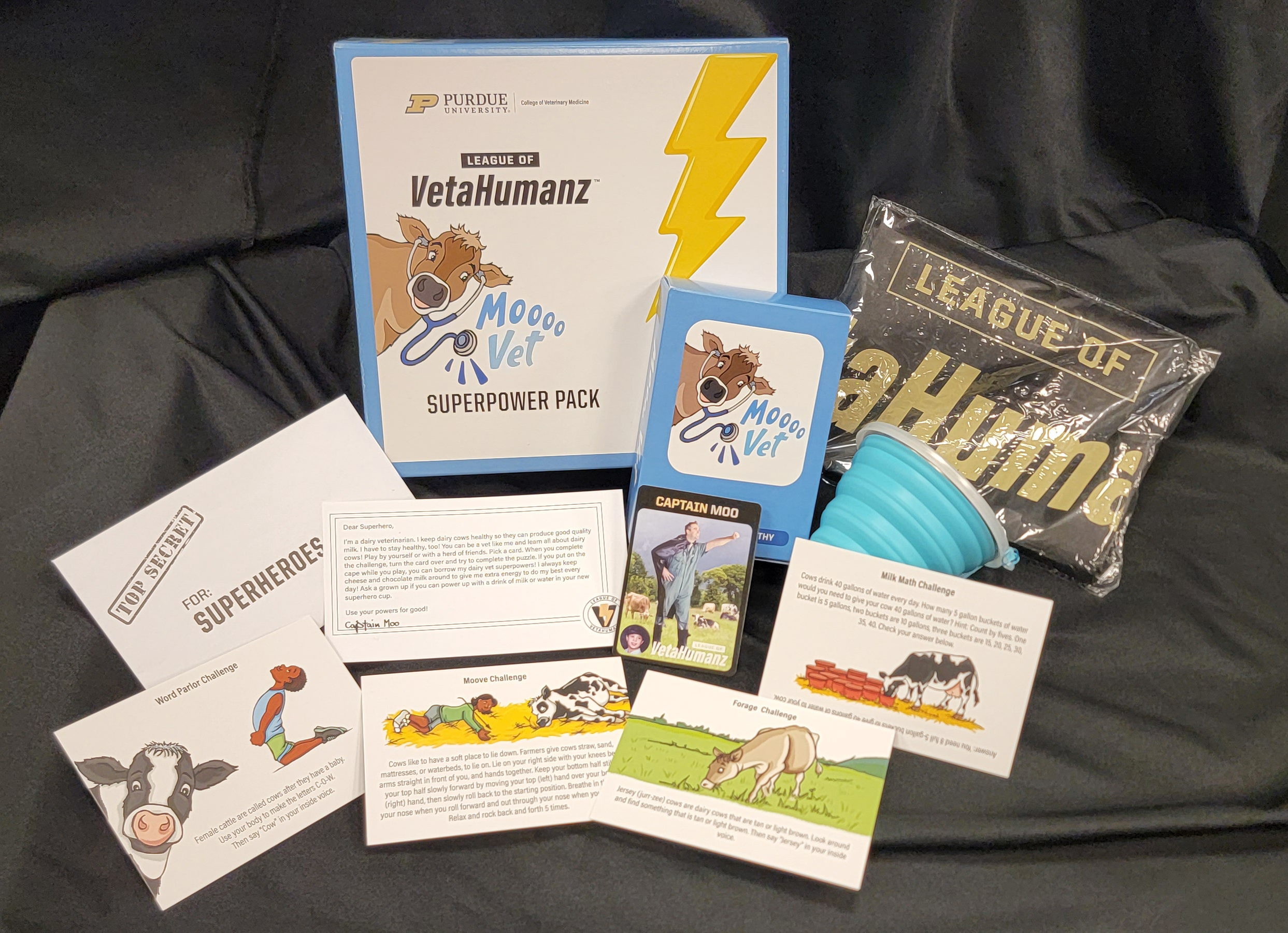 Moo Vet super power pack box contents including a cape and the Moo Vet game